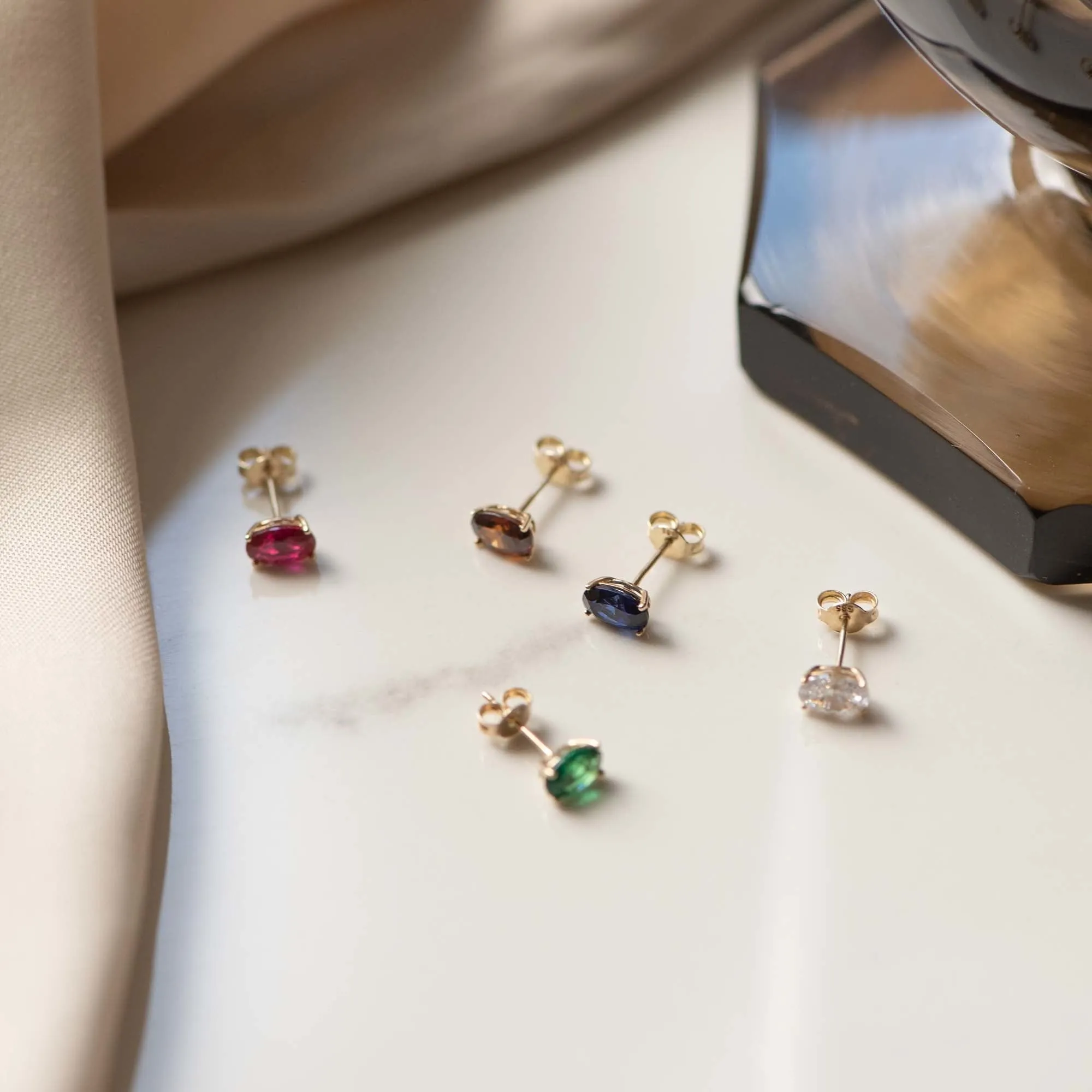 Baguette Olivia 14 karat gold stud ear studs with green zirconia stone